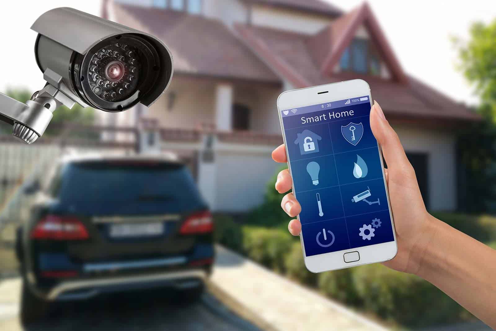 Image of smart phone with security options, a security camera, home and car