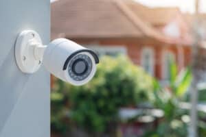 VOG Alarms White Home CCTV Cameras with Home Blurred in Background